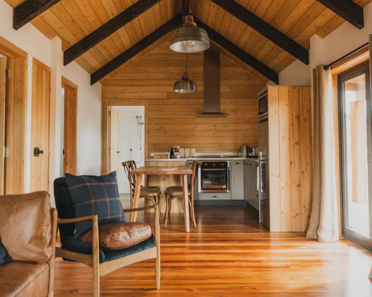 A view of the timber clad interior living space at James Mackenzie Lodge one of the best accommodation options at Lake Tekapo New Zealand