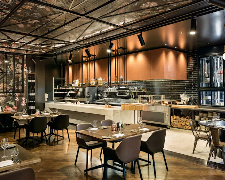 An open kitchen, a floral wall and black industrial accents.