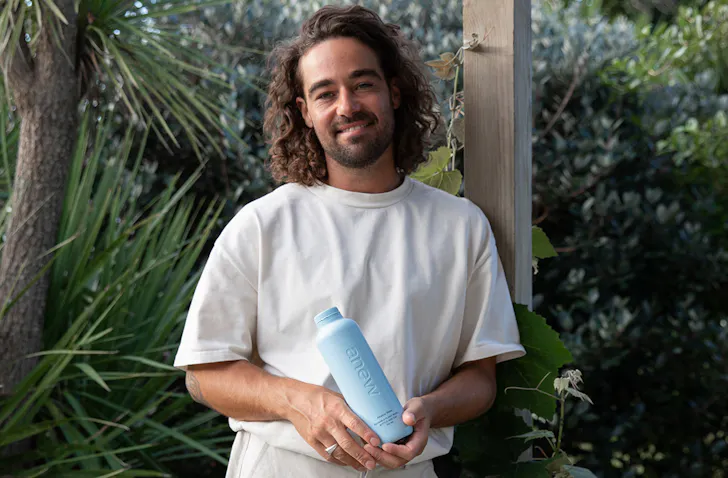 Jayden Klinac from Anew holds one of his reusable bottles.