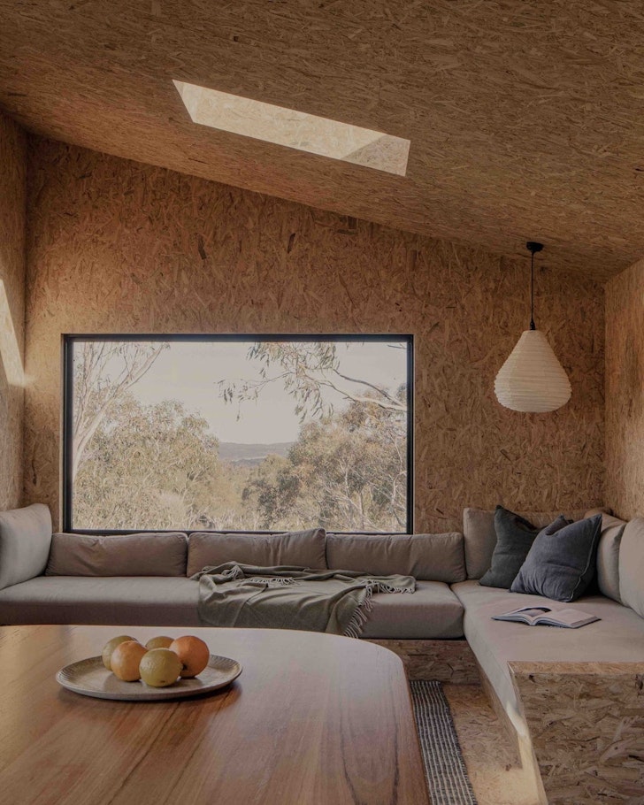 A view of the living space with views of nature at Common Kosci Airbnb one of the best accommodation options in Jindabyne