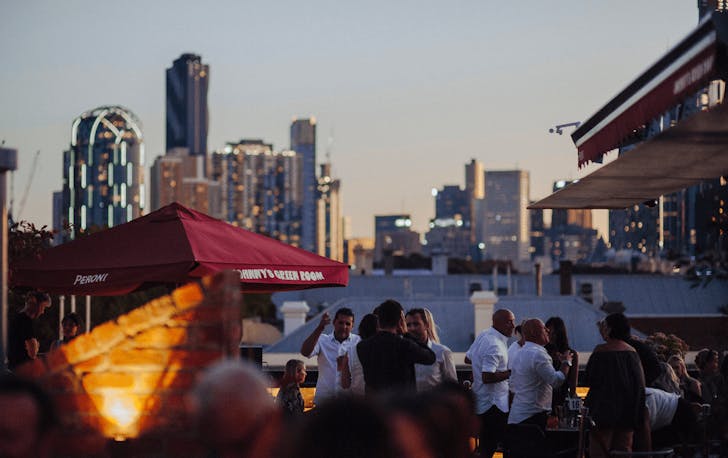 A rooftop bar at dusk with a best private dining rooms Melbourne. 