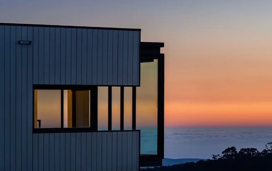 A box house overlooking the beach at sunset with one of the best romantic getaways in Victoria.