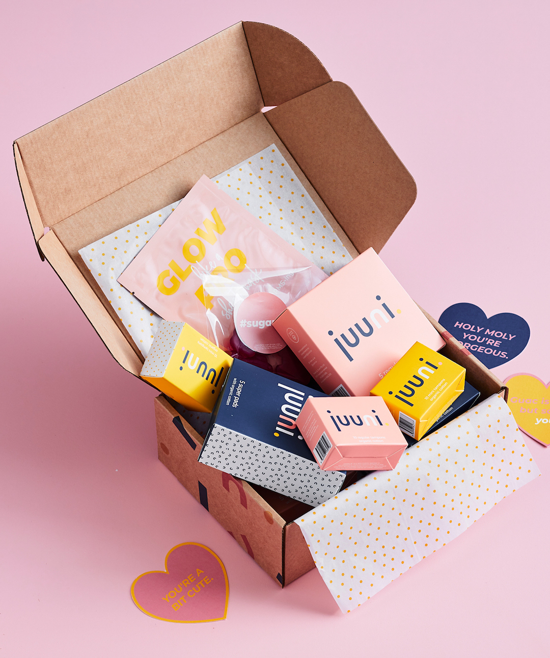 A cardboard box full of colourful Juuni tampons and pads. 