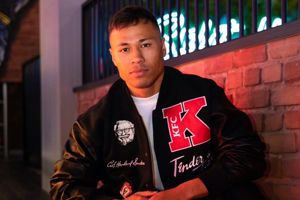 A person wearing the KFC Varsity Jacket