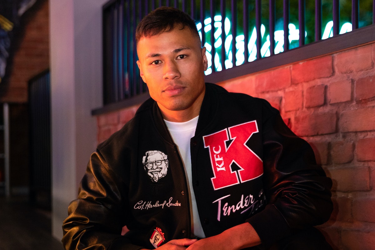 A person wearing the KFC Varsity Jacket
