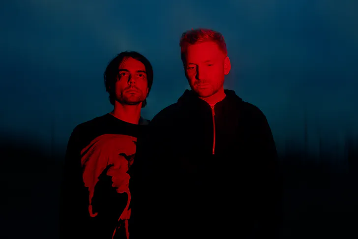 Two men standing next to each other.