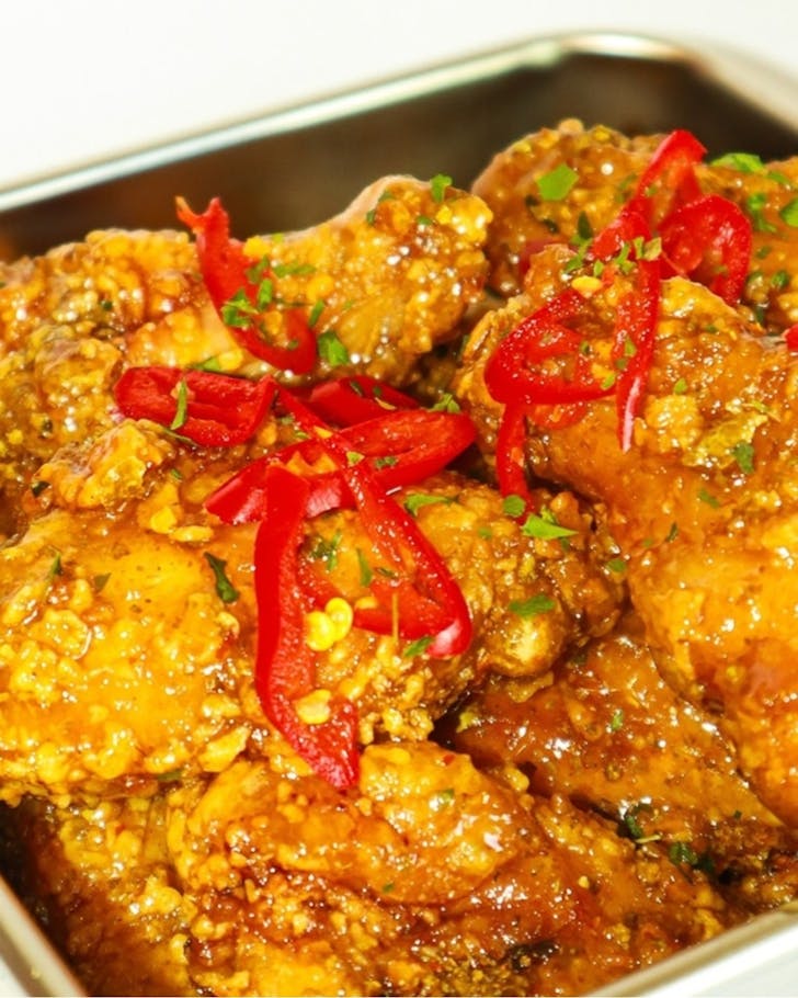 Crispy Korean fried chicken covered in hot honey butter sauce.