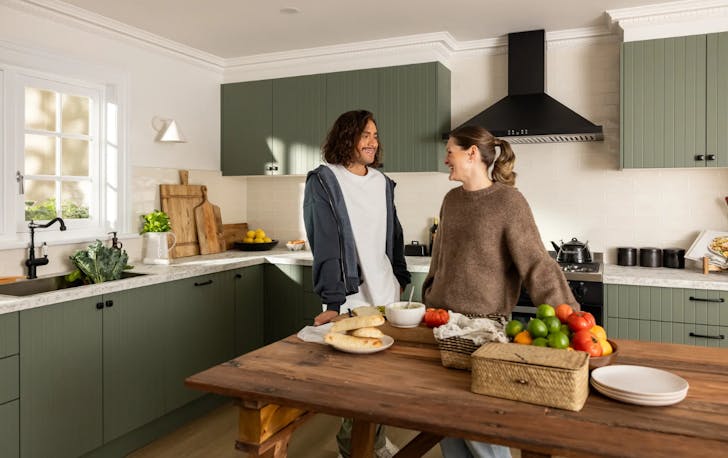 Two people standing in kitchen