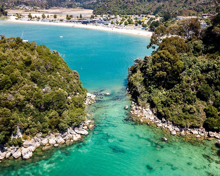 Kaiteriteri Around The Headlands showing green blue water and nearby islands.
