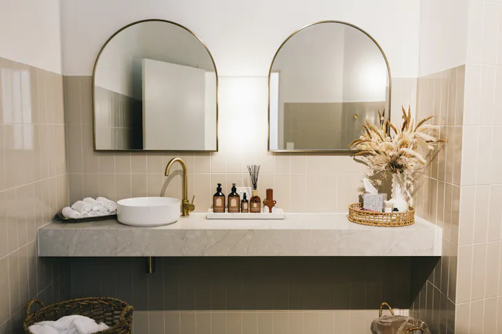 a sink with two mirrors