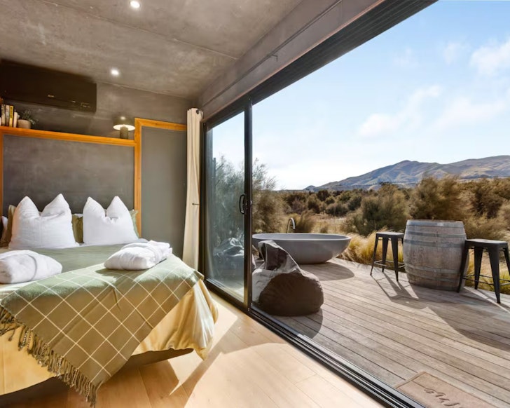 A view from the bedroom out to the mountains at Kanuka Valley Escape Tahi one of the best accommodation options in Wanaka New Zealand