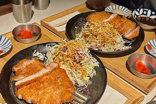 Two plates of krispy katsu and slaw.