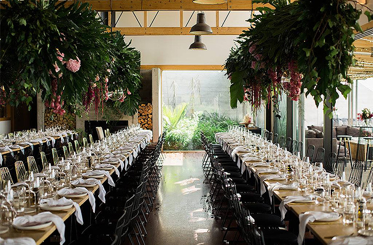 A long table decorated with beautiful flowers at Kauri Bay Boomrock.
