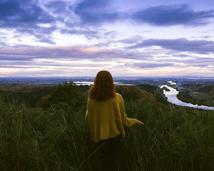 The author stands in front of an amazing sky on the Kauri Loop Walk.