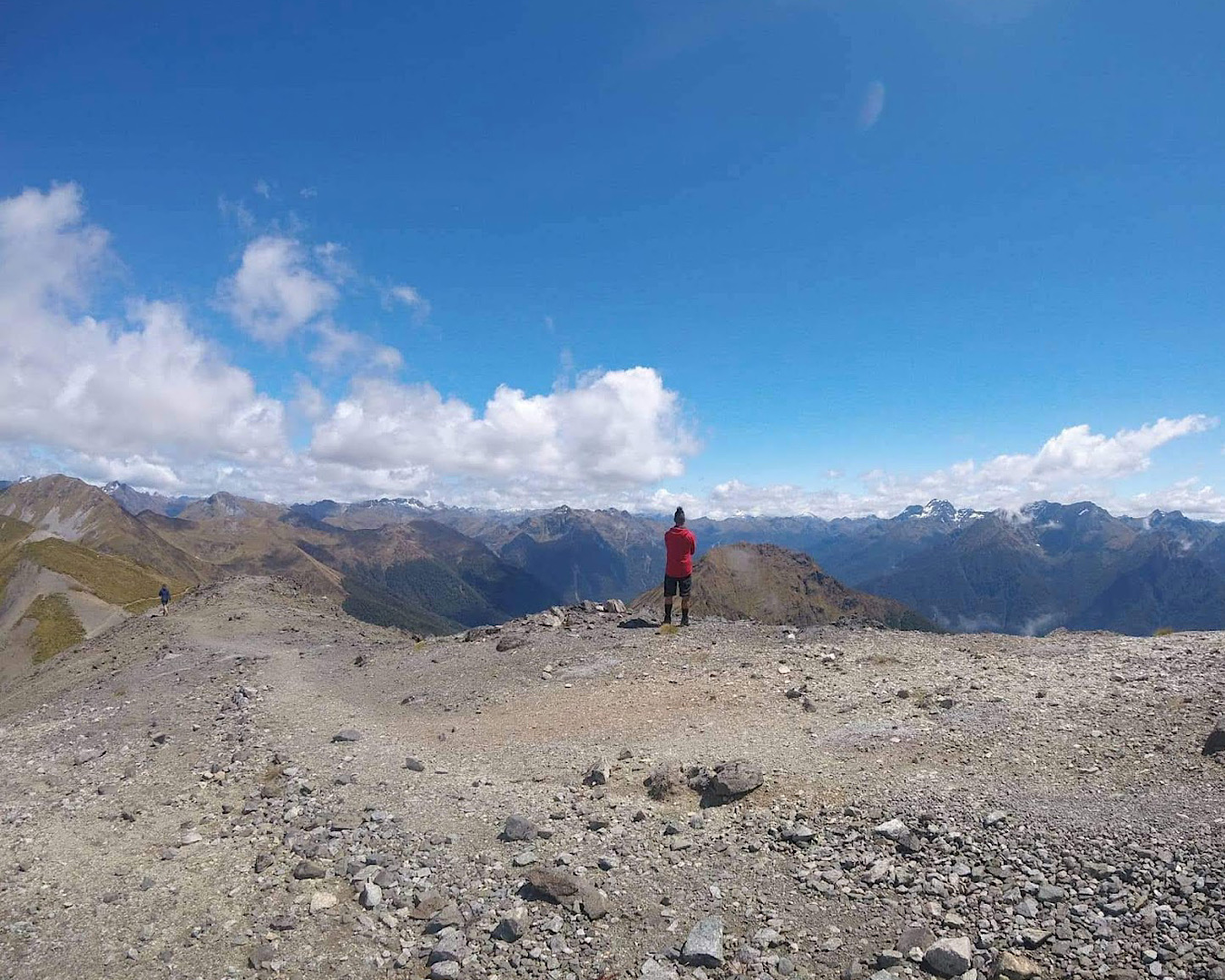 A hiker on the Kepler Track takes a moment to soak up the spectacular ridgeline views. 