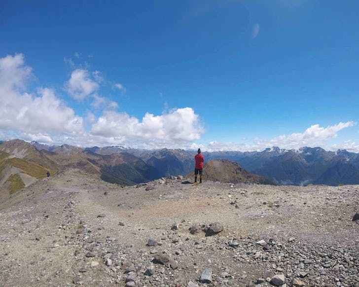 A hiker on the Kepler Track takes a moment to soak up the spectacular ridgeline views. 