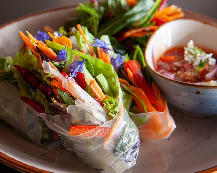 Khu Khu spring rolls looking fresh and delicious on a plate.