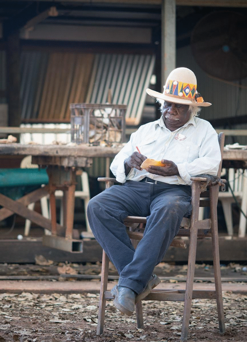 An Indigenous man works away on a pearl shell in Kimberley.