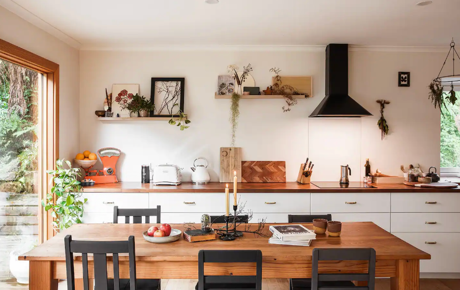 A kitschy kitchen with an open window at one of the best romantic getaways in Victoria.