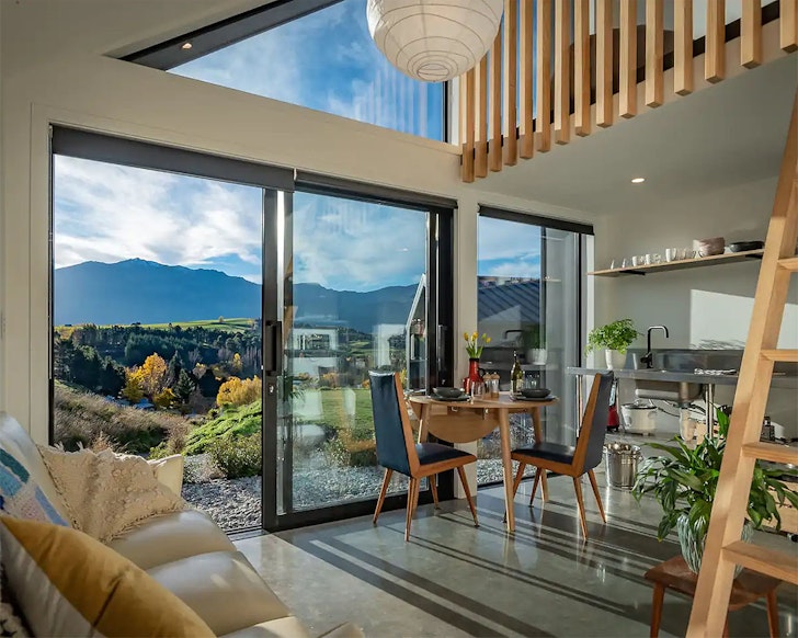 The cosy living space looking out to mountains at Kiwi Chalet one of the best Queenstown Airbnbs