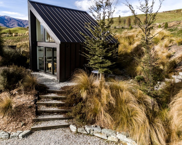 The black exterior of Kiwi Chalet on the hill, one of the best Queenstown accommodation options
