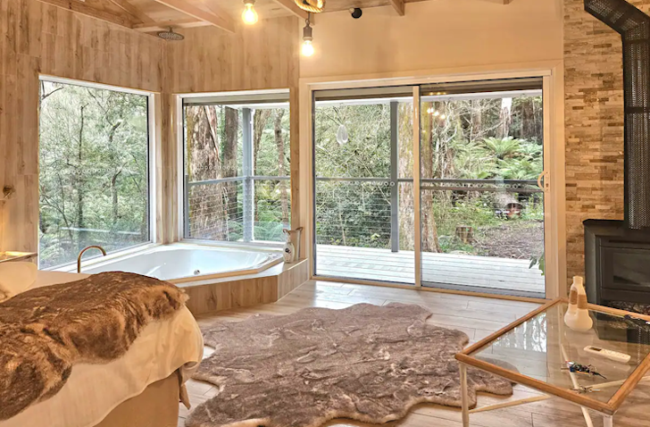 The living space and indoor fireplace at Klara's Spa Studio Airbnb Victoria