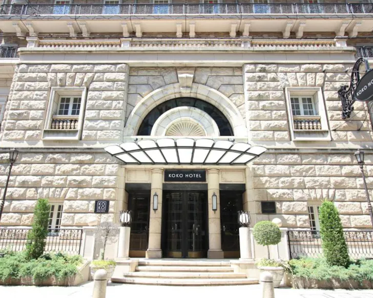 The beautiful white stone facade of Koko Hotel Osaka. 
