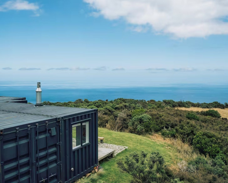 A view of Komaru Ridge shipping container Airbnb surrounded by wild landscape near Wellington 