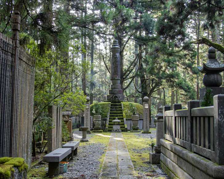 The quiet, forested Okunoin Cemetery with moss-covered shrines in Koyasan. 