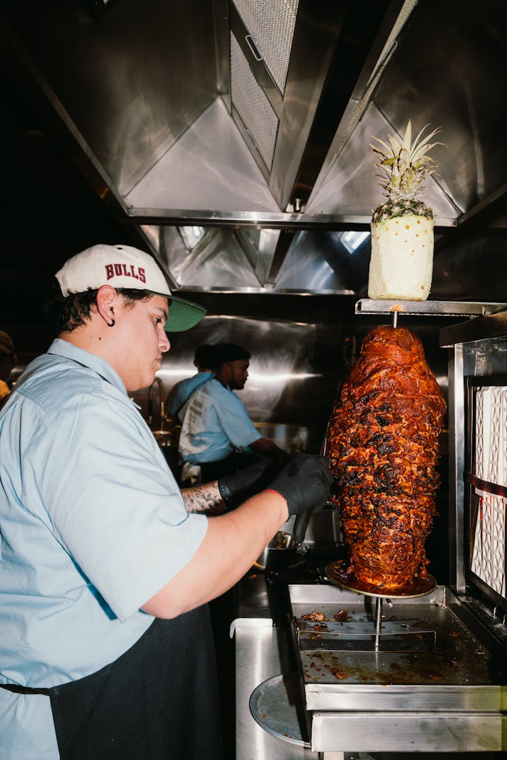 Chef standing by the rotating meat