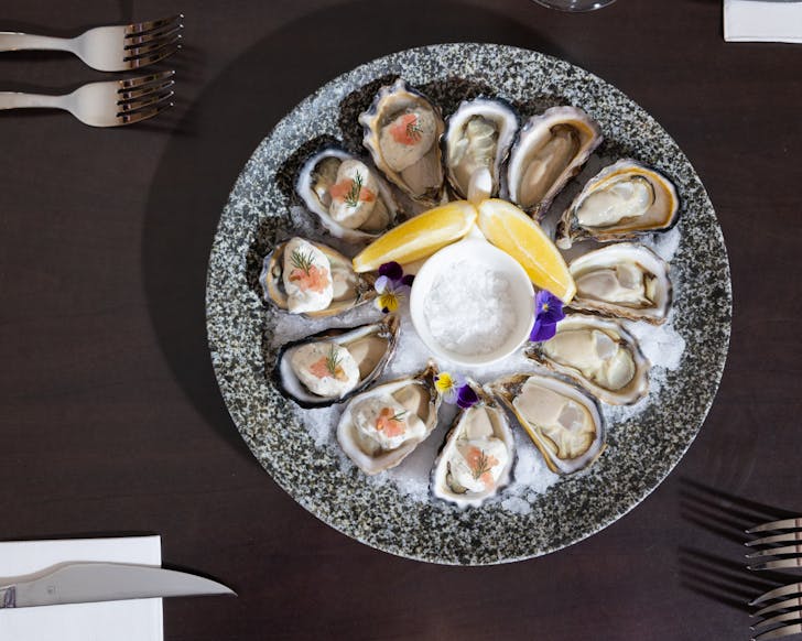 Plate of oysters on a black table