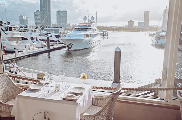 a restaurant view looking over the broadwater at sunset