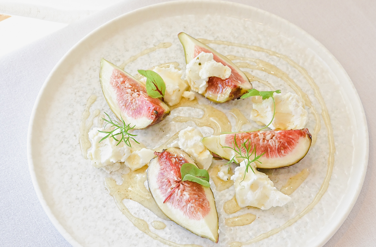 a closeup of a fig, feta and honey salad