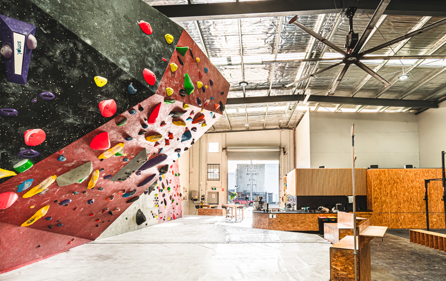 A large warehouse space with climbing challenges, rock climbing walls at a rock climbing Melbourne gym.