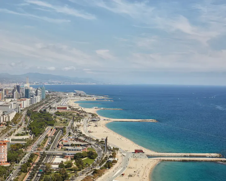 The beachfront and ocean at La Barceloneta in Barcelona. 