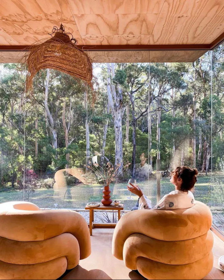 A woman enjoys a wine at Lande Home one of the best WA Airbnb stays