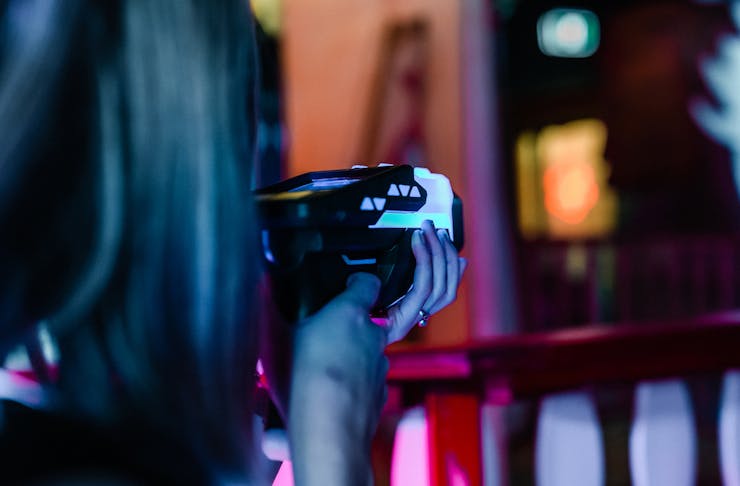 Person holding a laser tag gun and pointing at something