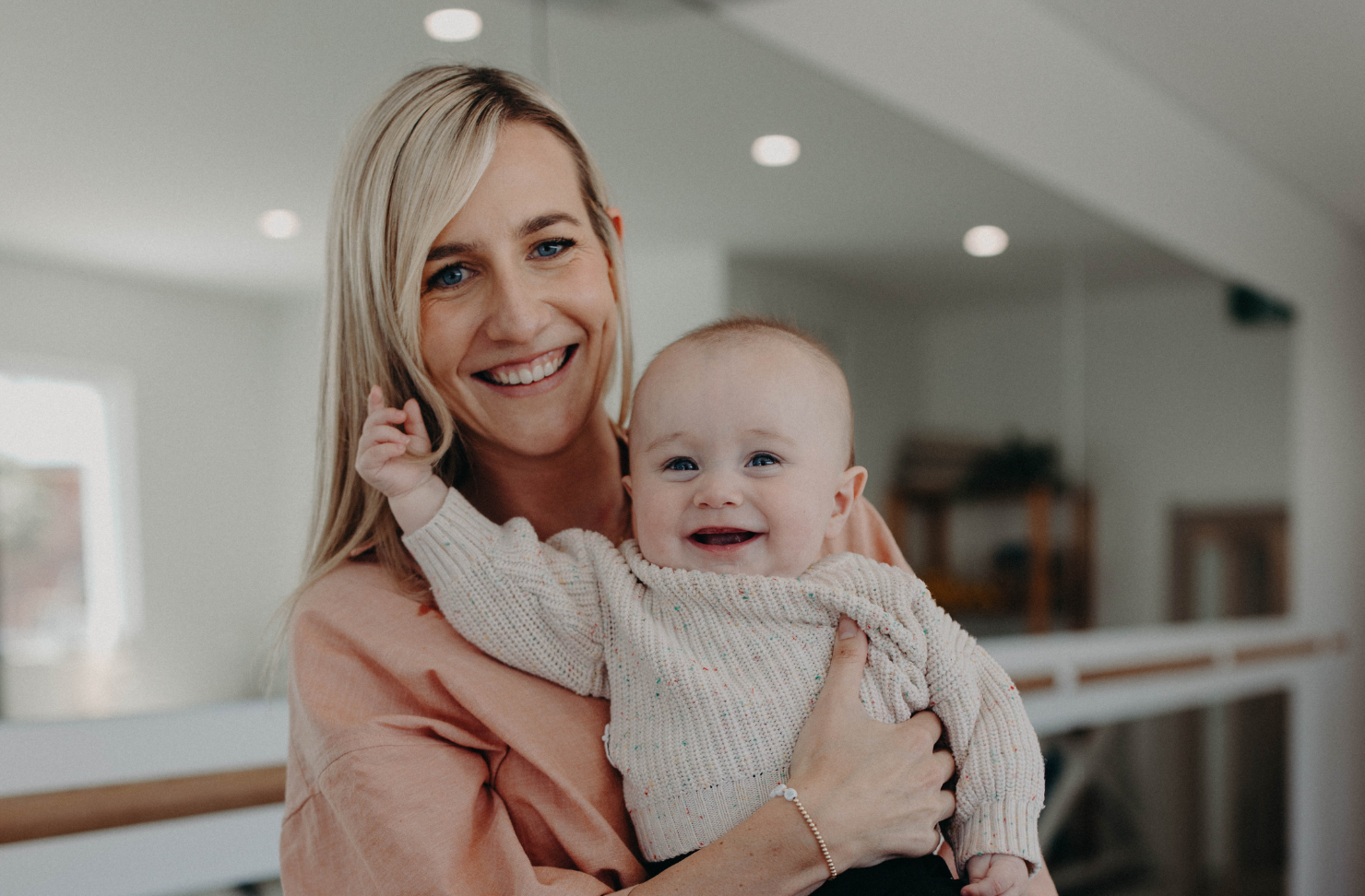 Midwife and mum of four Lauren Brenton holding a baby