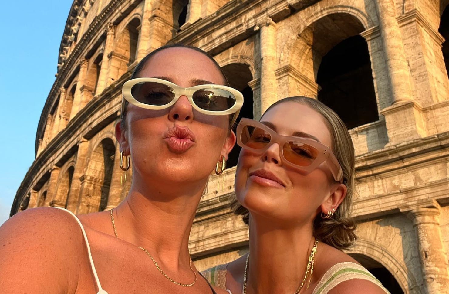 Two friends taking a selfie in front of the Colosseum 