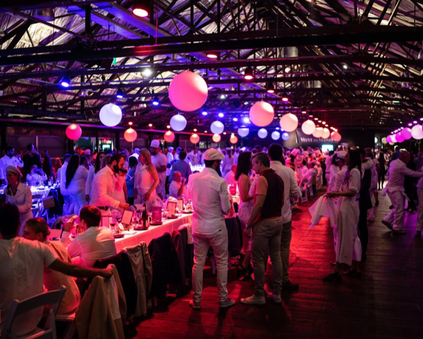 People dressed in white at Le Chef’s iconic French Festival. 