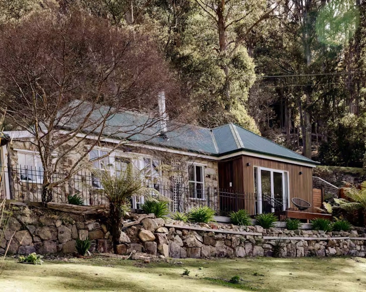 An exterior view of the stone frontage of Le Forestier one of the best Hobart Airbnbs