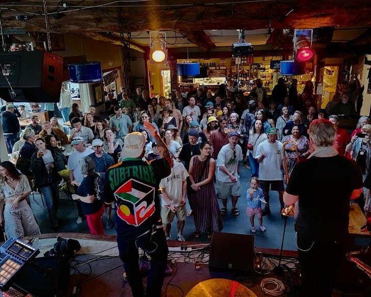 A crowd gather to watch live music at Leigh Sawmill.