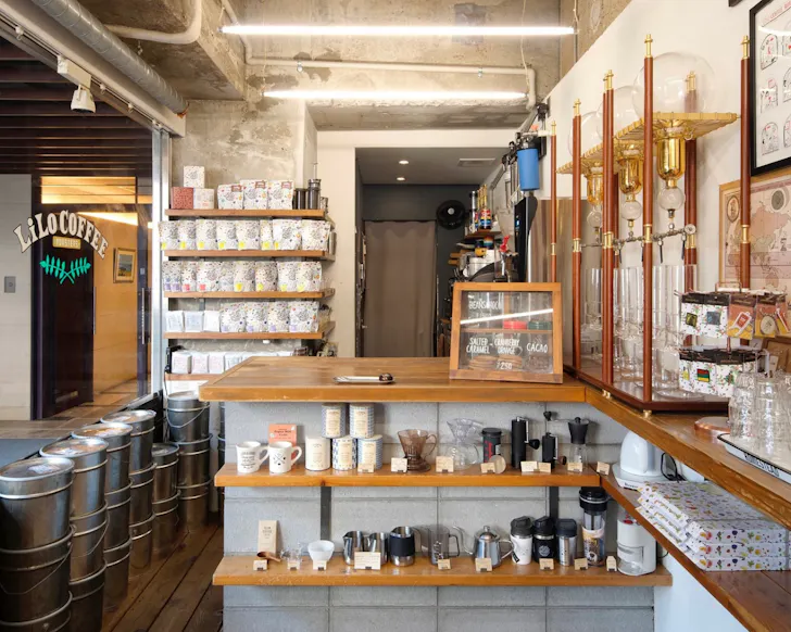 Shelves lined with coffee gear in the cosy store of LiLo Coffee Roasters in Osaka. 