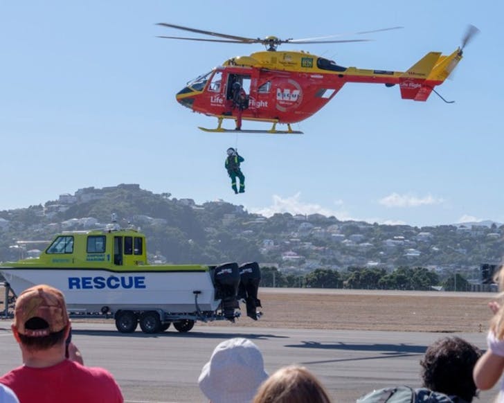 A helicopter gives a rescue demonstration with a winch