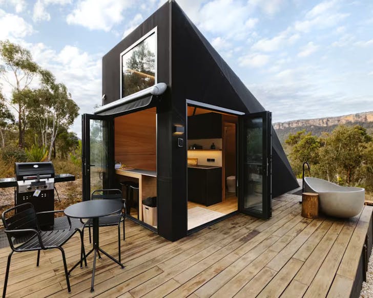 An exterior view of Ligo Airbnb NSW with outdoor bath on the deck