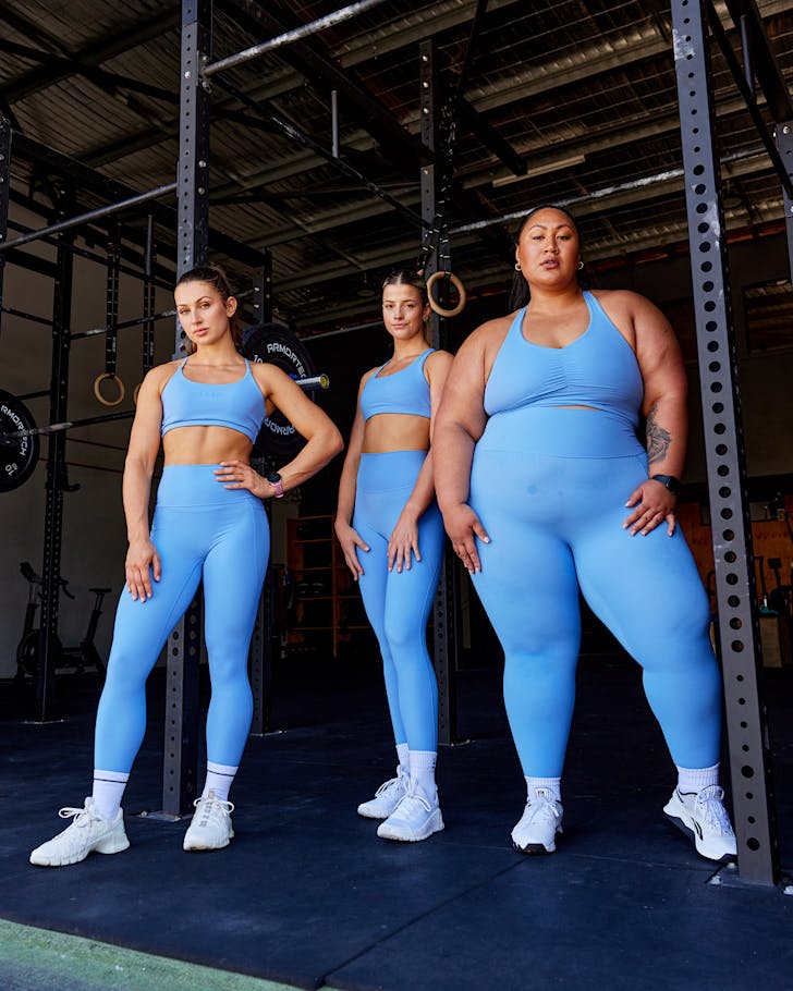 Lilz and two others pose in a gym in LSKD's new ultramarine Elixir leggings.