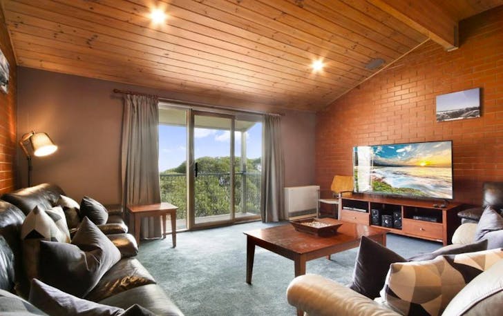 A heavy wooden cabin and lounge room, a best mt hotham accommodation