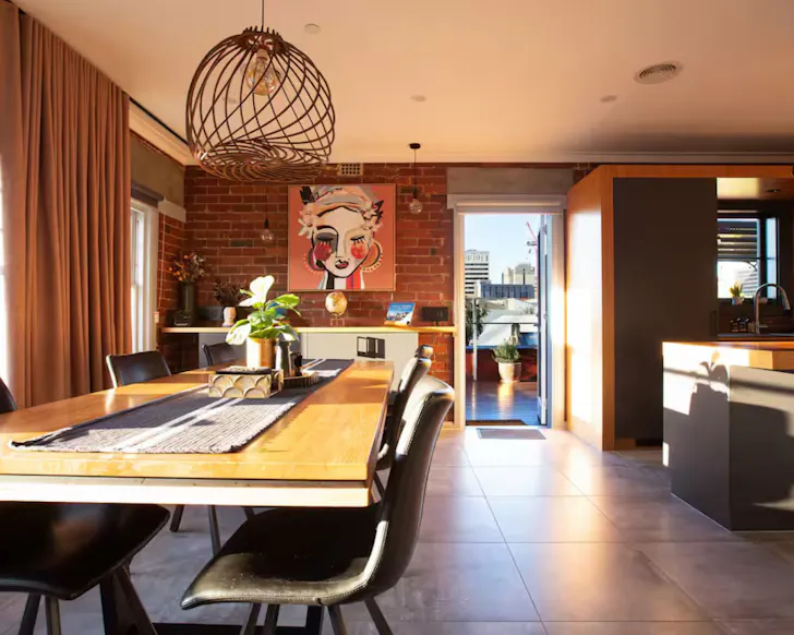 The living space with colourful artwork at Linear Guest Apartment one of the best Airbnbs in Hobart