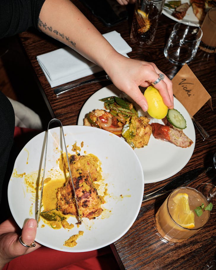 Vicki squeezes lemon over a Malaysian chicken dish.
