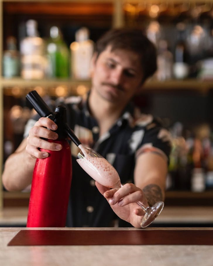 Bartender Liam at work creating a killer cocktail at Little Culprit, one of the best bars in Auckland. 